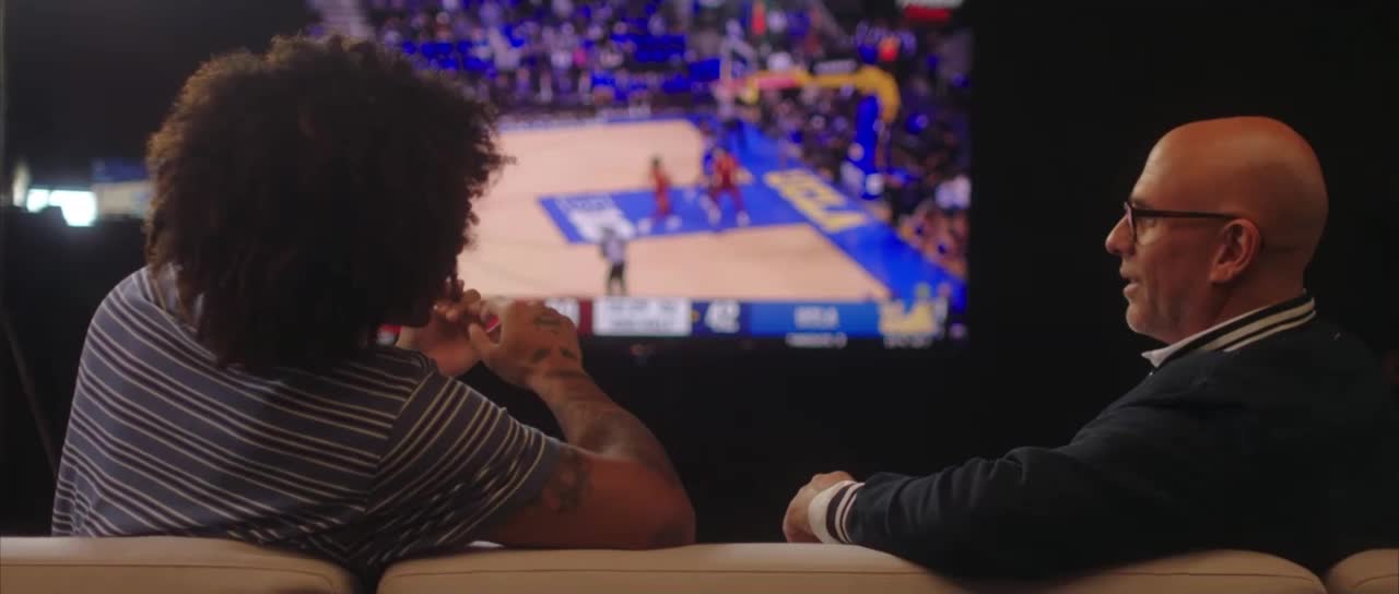Skyy and Rory sitting on the couch watching basketball